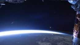 Na snímke z Medzinárodnej vesmírnej stanice pohľad na kométu C/2020 F3 Neowise (vľavo) nad planétou Zem.