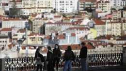 Skupina mladých ľudí s ochrannými rúškami v portugalskom meste Lisabon.