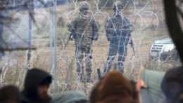 Na snímke poľskí príslušníci pohraničnej stráže hliadkujú pri plote s ostnatým drôtom