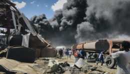 ľudia stoja pred oblakmi čierneho dymu po náletoch na muničné sklady vzbúrencov v etiópskom meste Mekele