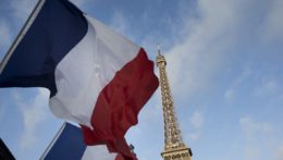 Francúzske zástavy vejú pred Eiffelovou vežou v Paríži.
