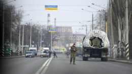 Ukrajinský vojak stojí na ceste vedľa vojenského vozidla v priemyselnom meste Kramatorsk v Doneckej oblasti.