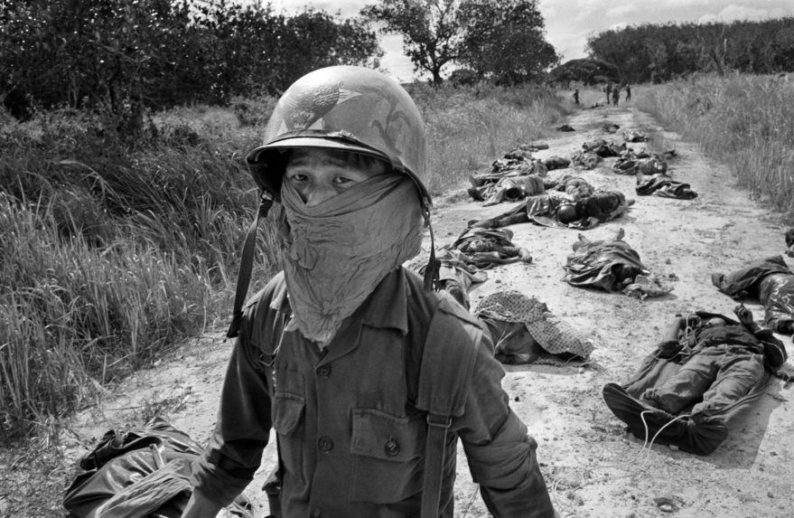 Na archívnej snímke Horsta Faasa z 27. novembra 1965 od vojnového fotografa agentúry AP Horsta Haasa, vietnamský vojak sa chráni handrou na tvári pred zápachom z rozkladajúcich sa mŕtvych tiel amerických a vietnamských vojakov.