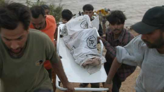 Na ilustračnej fotografii záchranári nesú telo obete.