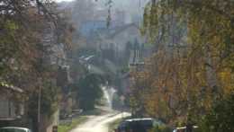 Na snímke ulica obce v jeseni so stĺpmi elektrického vedenia.
