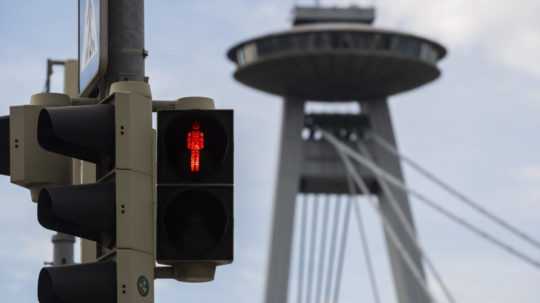 Na snímke semafor svieti na červeno na prechode pre chodcov, v pozadí bratislavský Most SNP.