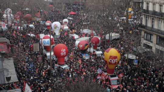 Demonštranti počas protestu proti vládnemu návrhu na zvýšenie zákonného veku odchodu do dôchodku v Paríži.
