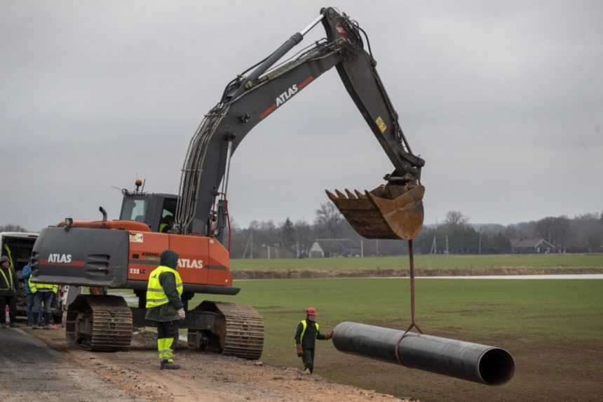 Zamestnanci opravujú plynovod po výbuchu neďalekej dediny Valakeliai na severe Litvy.