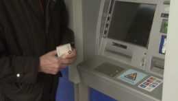 Na ilustračnej snímke muž stojí pri bankomate.