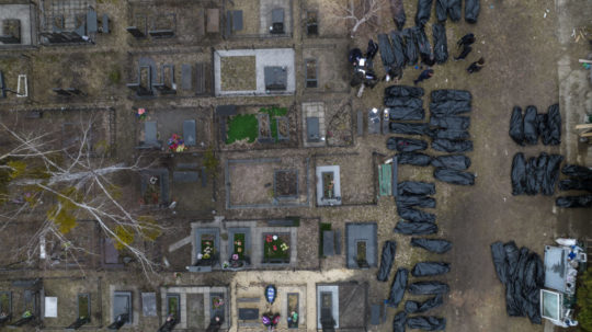 Policajti identifikujú mŕtve telá civilistov, ktorí boli zabití počas ruskej okupácie v meste Bucha pri Kyjeve.