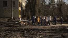 Kňaz slúži bohoslužbu na pamiatku obetí na mieste budovy, ktorú silno poškodil nálet a bola pred rokom zbúraná v ukrajinskom meste Boroďanka.