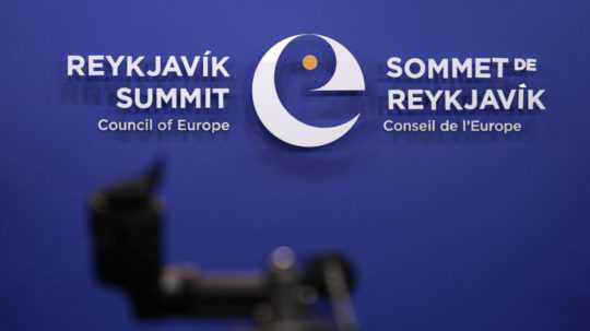 Televízna kamera stojí pred logom samitu Rady Európy v Reykjavíku na Islande.