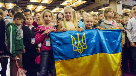 Na archívnej snímke deti držiace ukrajinskú vlajku.