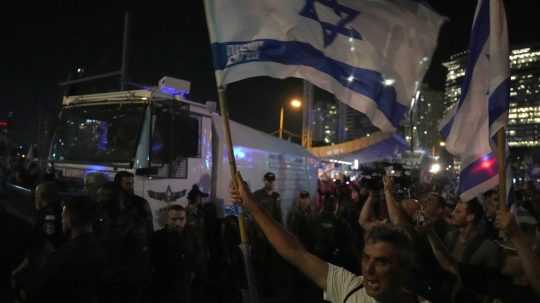 Na snímke demonštranti protestujú proti reformám súdnictva 24. júla 2023 v Tel Avive.