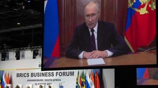 Na snímke Vladimír Putin sa prihovára cez veľkú obrazovku.