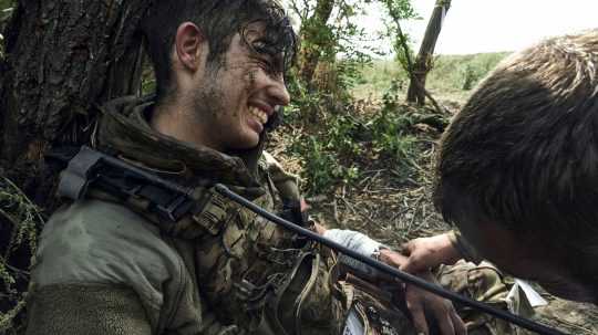 Ukrajinský vojak pomáha svojmu kolegovi neďaleko Bachmutu.