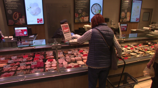 Žena v obchode nakupuje mäsové výrobky.