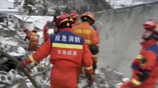 Na snímke z videozáznamu čínskej televízie CCTV záchranári prehľadávajú trosky po zosuve pôdy.