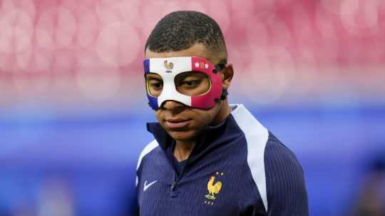 Francúz Kylian Mbappe trénuje s maskou na tvári.