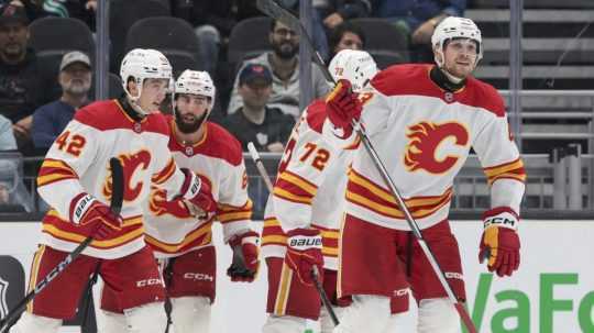 Hráči Calgary Flames aj so Samuelom Honzekom (vľavo) po strelení gólu.