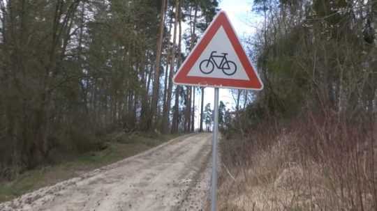 lesná cesta so značkou zákazu bicyklov.